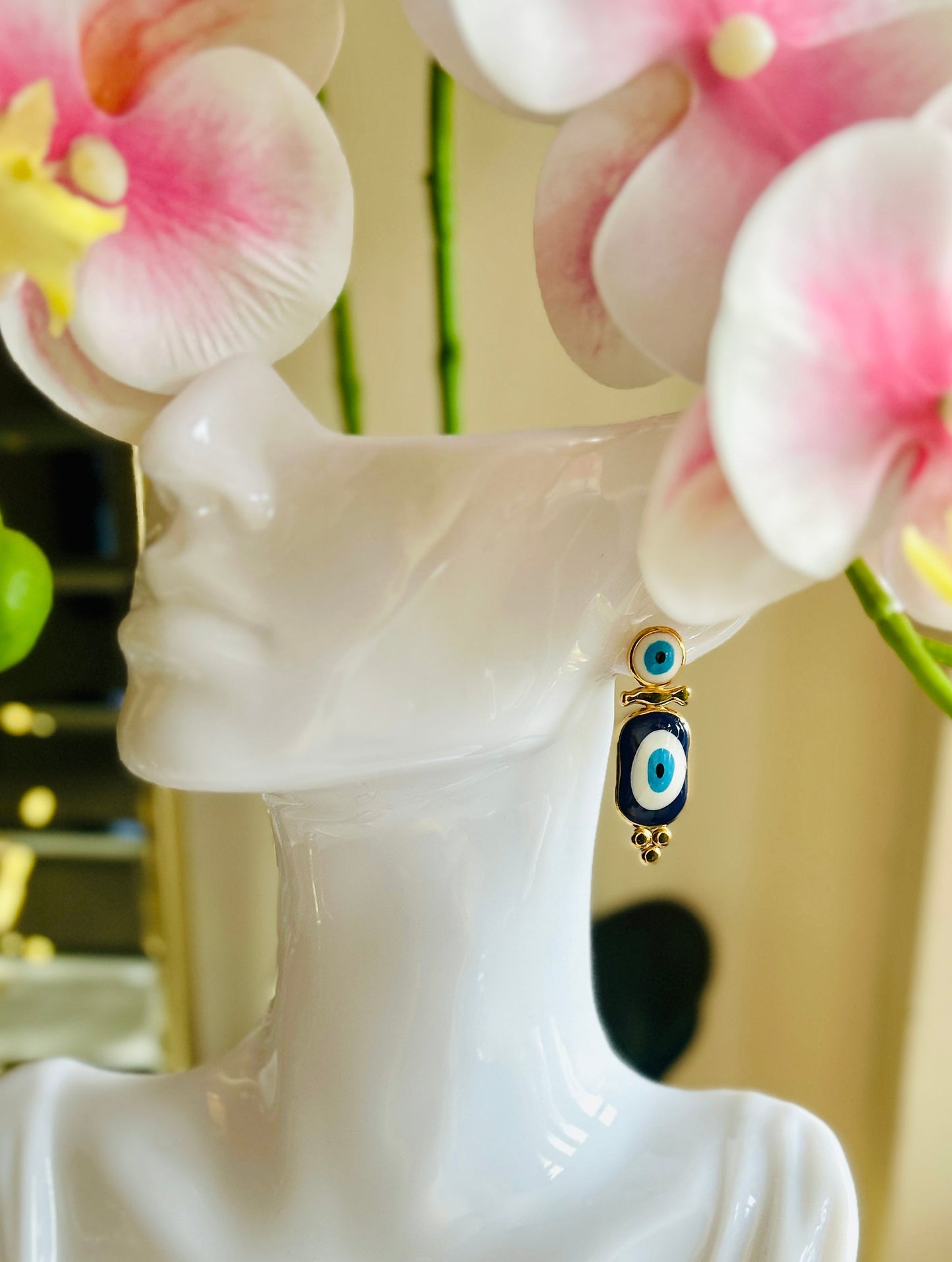 Devil Eye Earrings with stainless steel and 18k gold plating displayed on a mannequin.