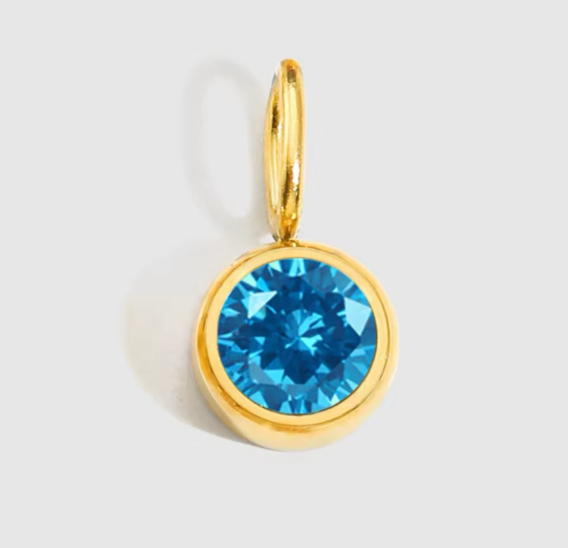 Birthstone Charm Necklace with blue gemstone and gold-plated setting.