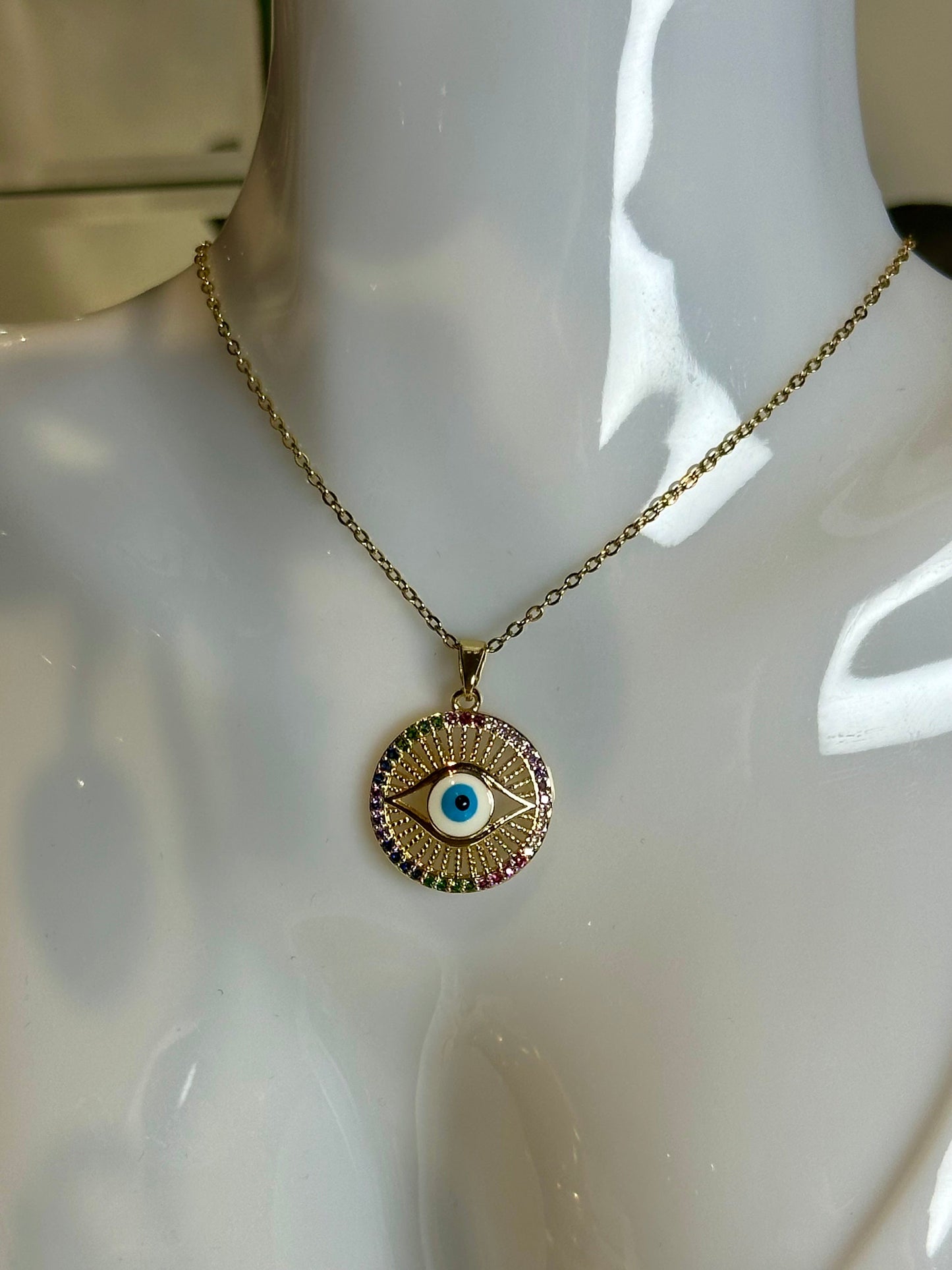 Evil Eye Pendant Necklace in gold and blue on mannequin.