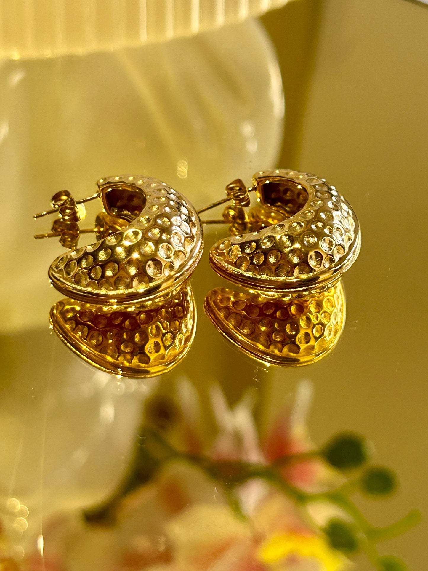 Moon Shape Hammer Earrings crafted in stainless steel with 18k gold coating displayed on a reflective surface.
