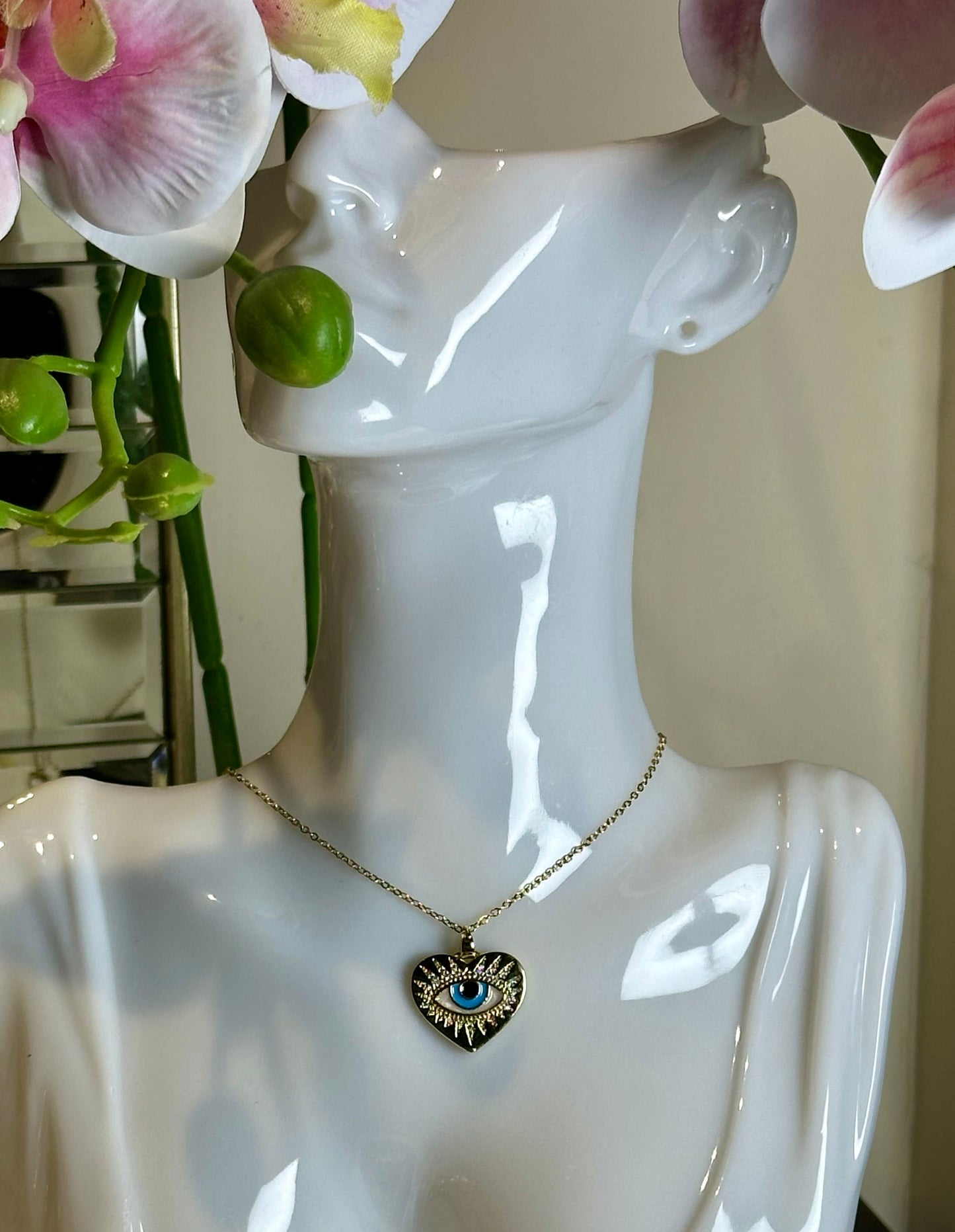 Evil Eye Pendant Necklace with gold and blue design on mannequin bust.