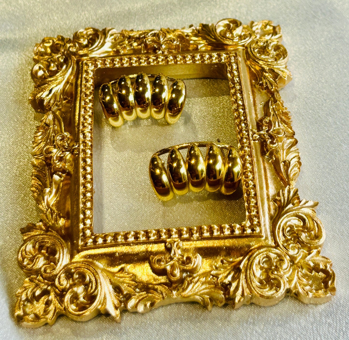 Striped Hollow Women Earring with 18k gold plating on ornate gold background.