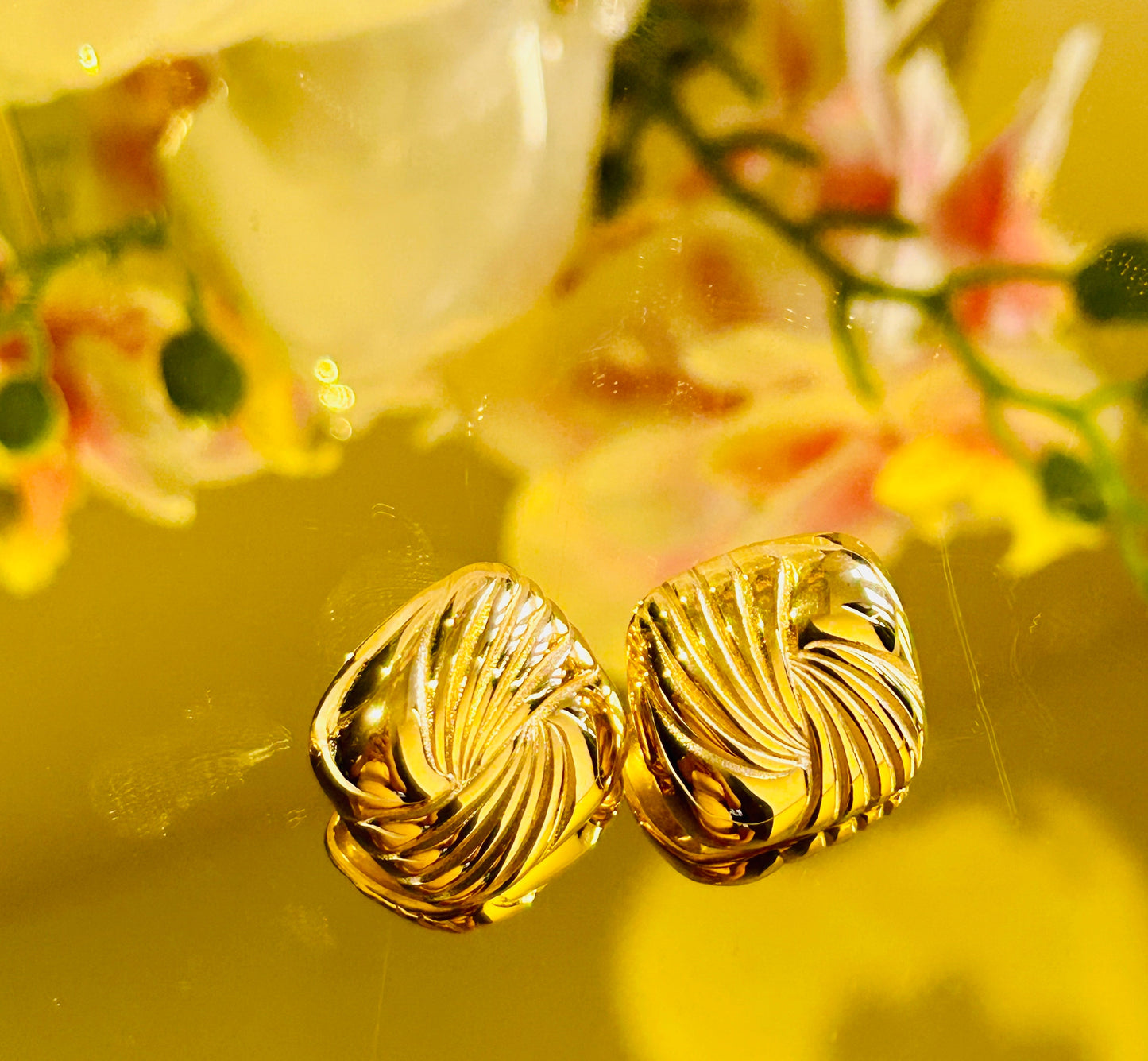 Square Spiral Vintage Earrings with 18k gold plating displaying elegant, timeless design on a reflective surface.
