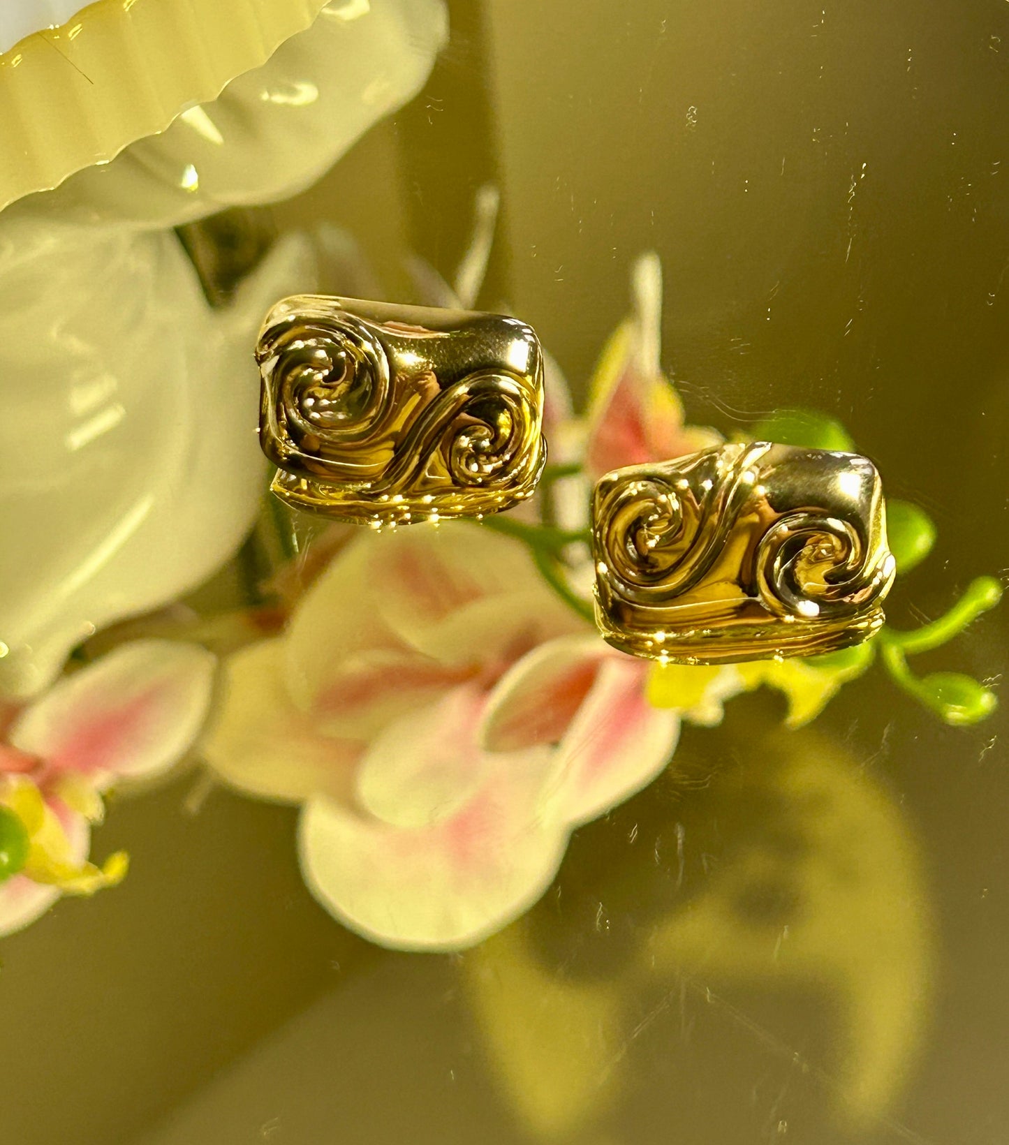 Square Embossed Spiral Earring with 18K gold plating and spiral design displayed on background.