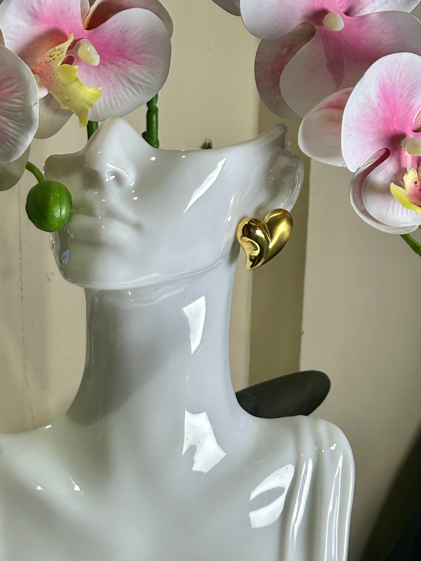 Heart Charms Love Earrings with 18k gold plating on display mannequin.