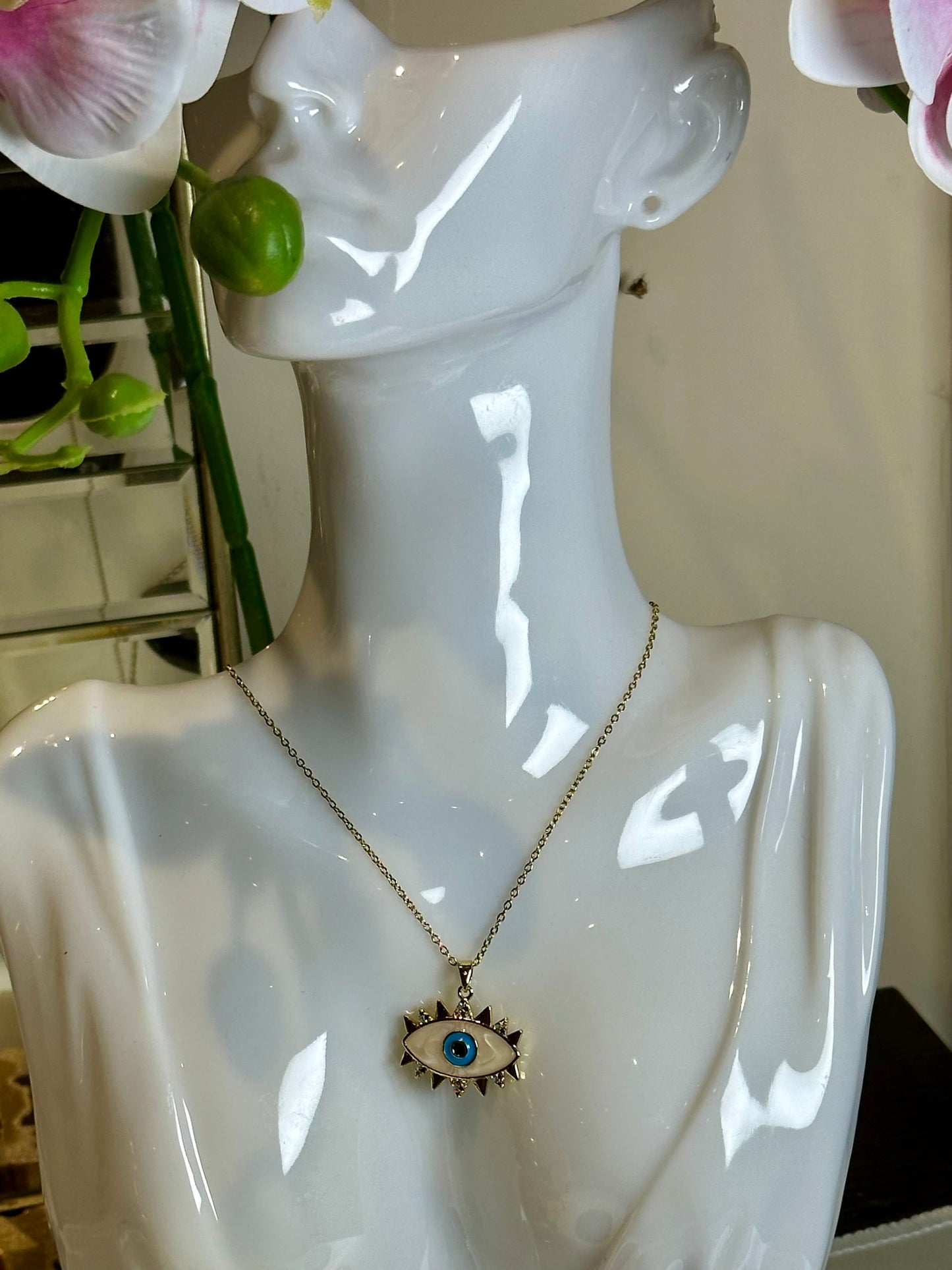 Evil Eye Pendant Necklace in 18K gold and blue design on mannequin.