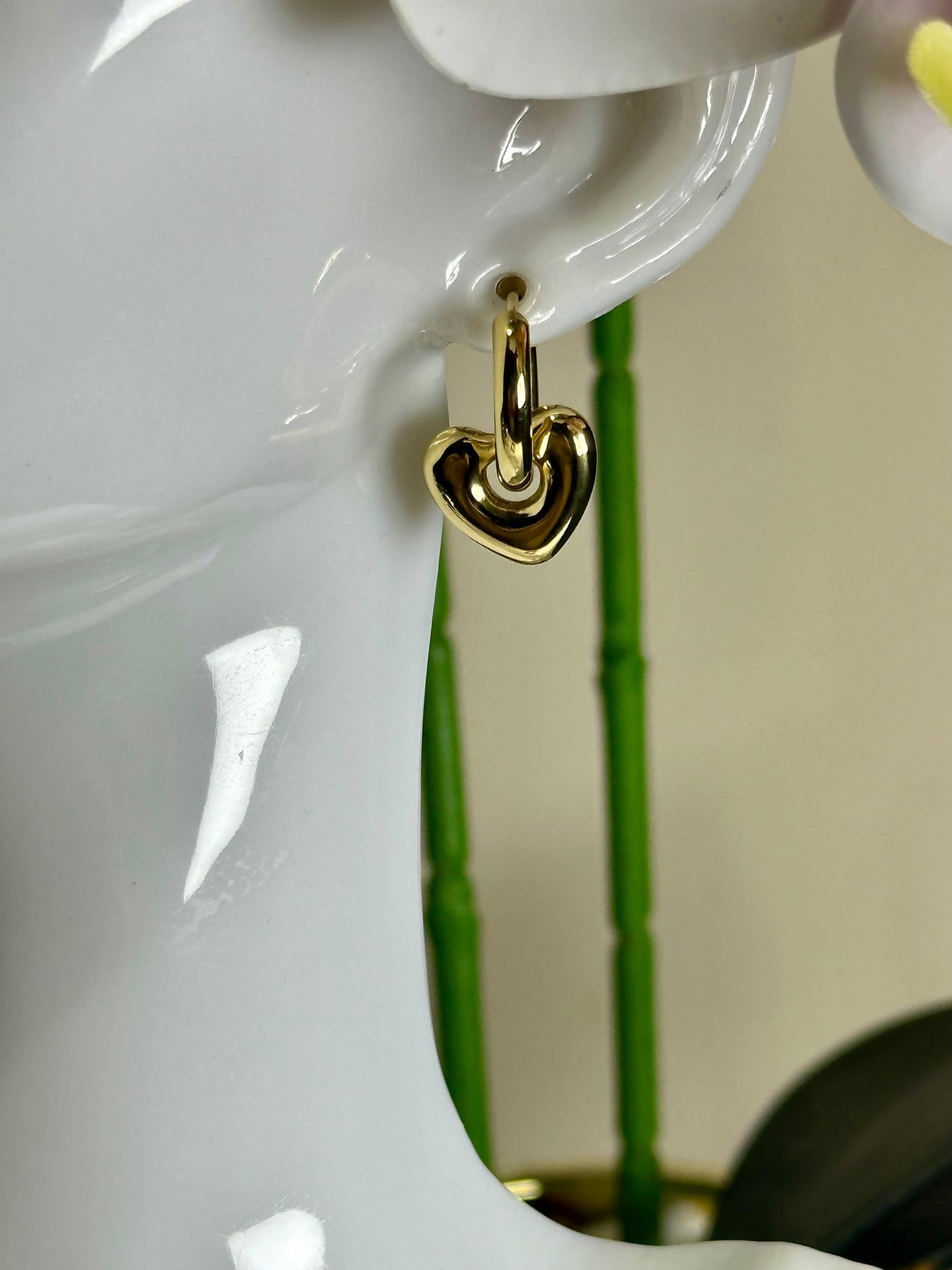 Heart Huggie Earring in stainless steel on display mannequin.