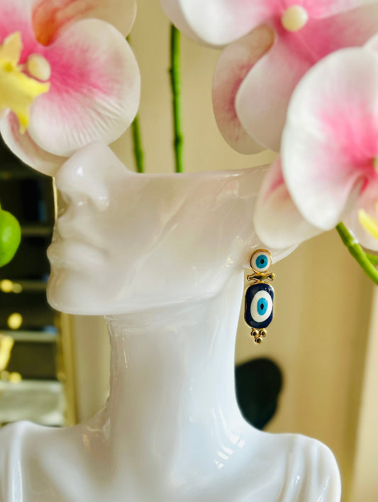 Devil Eye Earrings with stainless steel and 18k gold plating displayed on a mannequin.