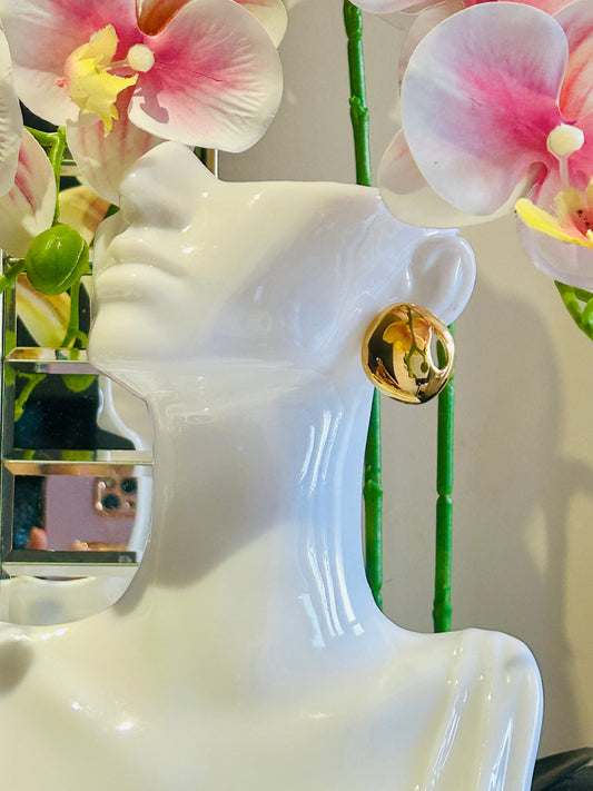 Hollow luxury stud earring in 18k gold plated stainless steel displayed on mannequin.