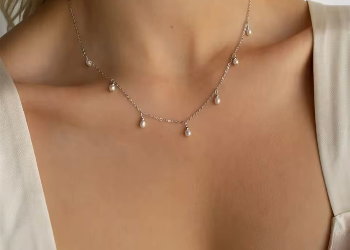Gold-Plated Stainless Steel Teardrop Imitation Pearl Necklace on woman's neck.